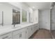 Spacious main bathroom with dual sinks, white cabinetry, quartz countertops, and framed mirrors at 779 Keystone Dr, Woodstock, GA 30188
