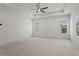 Large carpeted main bedroom with trey ceiling and windows overlooking backyard at 779 Keystone Dr, Woodstock, GA 30188