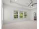Expansive main bedroom featuring backyard views from large windows and a trey ceiling with ceiling fan at 779 Keystone Dr, Woodstock, GA 30188
