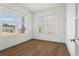 Bright and airy office space with hardwood floors and natural light streaming through large windows at 779 Keystone Dr, Woodstock, GA 30188