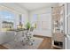 Bright home office featuring large windows, a modern desk, comfortable seating, and ample natural light at 779 Keystone Dr, Woodstock, GA 30188