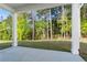 View from covered patio highlighting the serene backyard with lush greenery and mature trees at 779 Keystone Dr, Woodstock, GA 30188