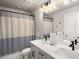Modern bathroom featuring dual sinks, sleek black fixtures, and a stylish shower curtain at 1008 Knoxboro Ln, Woodstock, GA 30188