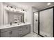 Modern bathroom with double vanity, gray cabinets, and glass-enclosed shower with marble tile at 1008 Knoxboro Ln, Woodstock, GA 30188
