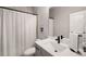 Well-lit bathroom with a single vanity, modern fixtures, and a shower with a curtain at 1008 Knoxboro Ln, Woodstock, GA 30188