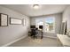 Bright bedroom with modern gray paint and a work-from-home setup near a window with views of the neighborhood at 1008 Knoxboro Ln, Woodstock, GA 30188