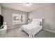 Bright bedroom with natural light, neutral decor, and a view of the outside neighborhood at 1008 Knoxboro Ln, Woodstock, GA 30188