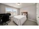 Cozy bedroom with a large window for natural light and space for a desk and bedroom furniture at 1008 Knoxboro Ln, Woodstock, GA 30188