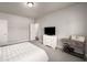 Bright bedroom with light gray walls, plush carpeting, white furniture, and a television at 1008 Knoxboro Ln, Woodstock, GA 30188