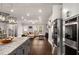 Open-concept kitchen flows into the living room, featuring stainless steel appliances and an island at 1008 Knoxboro Ln, Woodstock, GA 30188