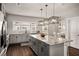 Open kitchen featuring granite counters, pendant lighting, modern appliances and hardwood floors at 1008 Knoxboro Ln, Woodstock, GA 30188