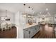 Open floorplan showcasing a kitchen with granite island, dining area, and inviting living room at 1008 Knoxboro Ln, Woodstock, GA 30188