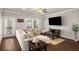 Inviting living room with cozy seating, hardwood floors, and lots of natural light at 1008 Knoxboro Ln, Woodstock, GA 30188
