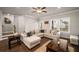 Comfortable living room features a large sectional couch, wood floors, and abundant natural light at 1008 Knoxboro Ln, Woodstock, GA 30188