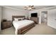 Spacious main bedroom features a TV, walk-in closet, and neutral color palette at 1008 Knoxboro Ln, Woodstock, GA 30188