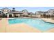 Community pool with sundeck and lounge chairs in a beautiful setting at 1008 Knoxboro Ln, Woodstock, GA 30188