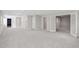 Spacious finished basement with neutral carpet, gray walls, and multiple doorways for versatile use at 1755 Pinetree Pass Sw Ln, Lilburn, GA 30047