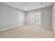 Cozy basement area with soft carpeting, recessed lighting, and French doors leading to another room at 1755 Pinetree Pass Sw Ln, Lilburn, GA 30047