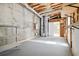 Exposed basement with visible pipes, shelving, and a white door to another area at 1755 Pinetree Pass Sw Ln, Lilburn, GA 30047