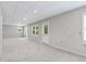 Finished basement featuring plush carpeting, recessed lighting, and bright windows overlooking the yard at 1755 Pinetree Pass Sw Ln, Lilburn, GA 30047
