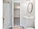Bright bathroom featuring a vanity, oval mirror, toilet, and a shower with a white shower curtain at 1755 Pinetree Pass Sw Ln, Lilburn, GA 30047