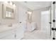 Bright bathroom with dual sinks, white cabinets, tile floors, and decorative mirrors at 1755 Pinetree Pass Sw Ln, Lilburn, GA 30047