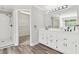Bathroom featuring a step-in shower and dual vanity sinks at 1755 Pinetree Pass Sw Ln, Lilburn, GA 30047