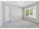 This bedroom has plush carpet and a double window at 1755 Pinetree Pass Sw Ln, Lilburn, GA 30047