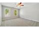 Bright bedroom featuring two large windows, neutral walls, and soft carpeting at 1755 Pinetree Pass Sw Ln, Lilburn, GA 30047