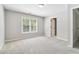 Spacious bedroom with neutral walls, carpeted floors, and a large window providing natural light at 1755 Pinetree Pass Sw Ln, Lilburn, GA 30047