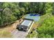 Aerial view showcases pool, tennis courts and playground surrounded by lush greenery at 1755 Pinetree Pass Sw Ln, Lilburn, GA 30047