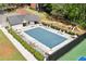 Aerial view of the pool, lounge chairs, tables, and playground area in the community at 1755 Pinetree Pass Sw Ln, Lilburn, GA 30047