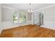 Elegant dining room featuring hardwood floors, wainscoting, and a stylish chandelier at 1755 Pinetree Pass Sw Ln, Lilburn, GA 30047