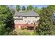 Rear view of a two-story house with a deck and walkout basement at 1755 Pinetree Pass Sw Ln, Lilburn, GA 30047