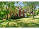 Two-story brick home with lush landscaping and a well-manicured lawn at 1755 Pinetree Pass Sw Ln, Lilburn, GA 30047