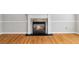 Close-up of fireplace with hardwood flooring at 1755 Pinetree Pass Sw Ln, Lilburn, GA 30047