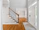 Bright foyer with hardwood floors, staircase, and view into the adjacent living area at 1755 Pinetree Pass Sw Ln, Lilburn, GA 30047