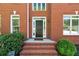Close-up of the classic front door with brick steps, framed by sidelights and lush landscaping at 1755 Pinetree Pass Sw Ln, Lilburn, GA 30047