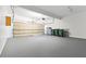 Spacious garage with an open door, storage shelves, and room for multiple vehicles at 1755 Pinetree Pass Sw Ln, Lilburn, GA 30047