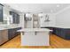 Modern kitchen with navy blue cabinets, granite counters, stainless appliances, and a center island at 1755 Pinetree Pass Sw Ln, Lilburn, GA 30047