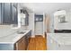 Bright kitchen featuring modern finishes, a large island, stainless steel appliances, and hardwood floors at 1755 Pinetree Pass Sw Ln, Lilburn, GA 30047