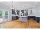 Open kitchen with hardwood floors, an island, stainless appliances, and double doors to the deck at 1755 Pinetree Pass Sw Ln, Lilburn, GA 30047