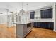 Open kitchen with island, stainless appliances, granite countertops, and hardwood flooring at 1755 Pinetree Pass Sw Ln, Lilburn, GA 30047