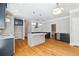 Open kitchen with hardwood floors, granite countertops, stainless steel appliances, and island at 1755 Pinetree Pass Sw Ln, Lilburn, GA 30047