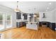 Well-lit kitchen with dark cabinetry, stainless steel appliances, and a central island with a stone countertop at 1755 Pinetree Pass Sw Ln, Lilburn, GA 30047