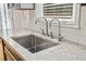 Kitchen sink with granite countertops and stainless steel faucet at 1755 Pinetree Pass Sw Ln, Lilburn, GA 30047