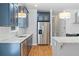 Well-lit kitchen with granite countertops, stainless appliances, and hardwood floors at 1755 Pinetree Pass Sw Ln, Lilburn, GA 30047