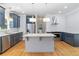 Modern kitchen with granite countertops, stainless steel appliances, island with seating, and stylish lighting at 1755 Pinetree Pass Sw Ln, Lilburn, GA 30047