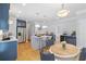 Well-lit kitchen features stainless steel appliances, a center island, and a dining area with seating at 1755 Pinetree Pass Sw Ln, Lilburn, GA 30047