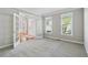 Inviting room with neutral carpet, windows, and french doors for ample sunlight at 1755 Pinetree Pass Sw Ln, Lilburn, GA 30047